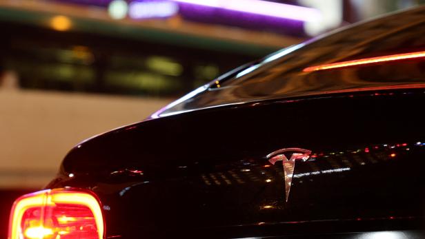 A Tesla logo is seen on a Parisian taxi car in Paris
